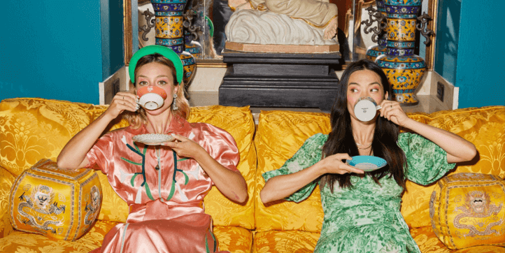 Women sat on a sofa drinking from Wedgwood fine china teacups and saucers